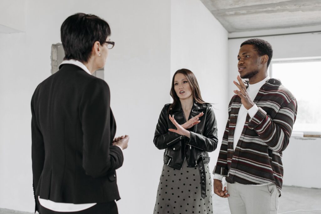 A sales professional with emotional intelligence talking to two clients