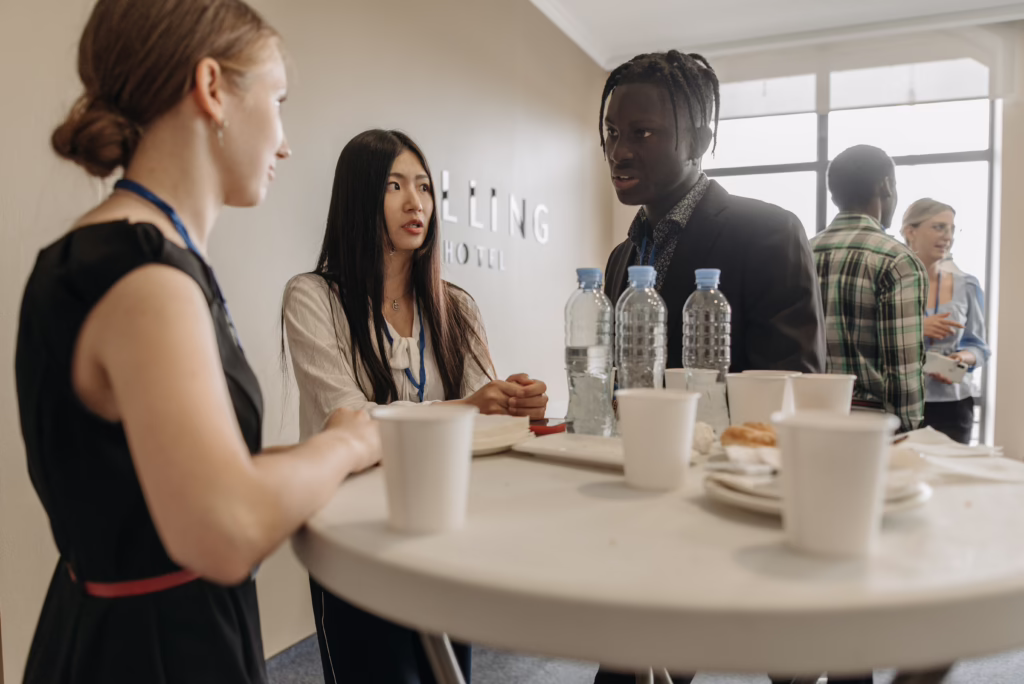 Professionals networking at a business event and discussing career growth opportunities